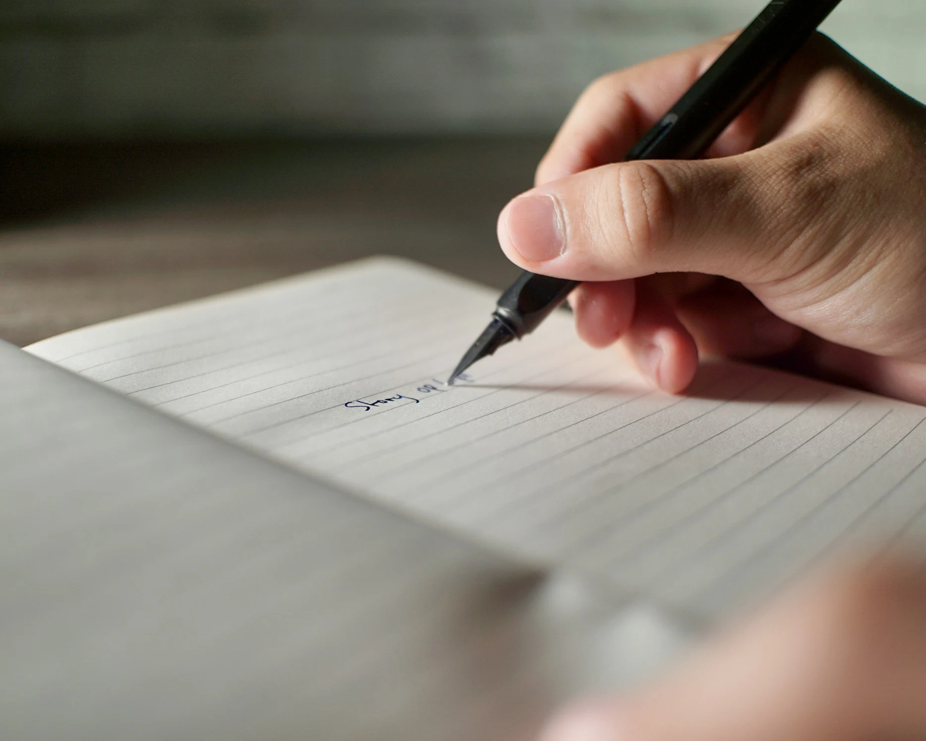 A hand writing on paper